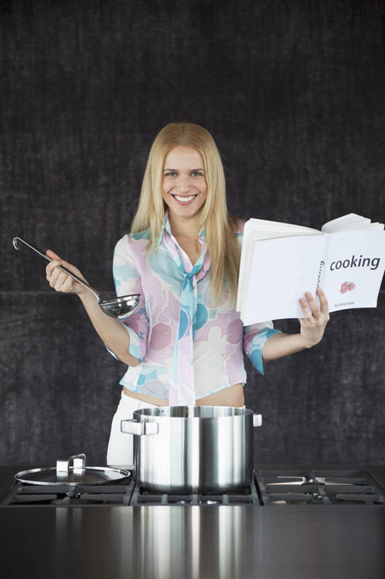 西方人,一个人,站,举,笑,微笑,竖图,室内,白天,侧面,烹饪,厨房,桌面,桌子,厨具,书籍,金属制品,欧洲,欧洲人,仅一个年轻女性,仅一个女性,仅一个人,握,阴影,服装,反射,金属,炖锅,锅子,影子,墙,注视,休闲装,锅,墙壁,墙面,衣服,观察,看,托,站着,休闲,休闲服,菜谱,握着,服饰,锅具,观看,灶具,察看,关注,燃气灶,烹饪用具,食谱,燃气具,年轻女性,女人,女性,白种人,烹调用具,书,图书,举起,举手,举着,烹调,向上举,向上伸,向上托,站立,半身,彩图,灶间,厨房料理台,料理台